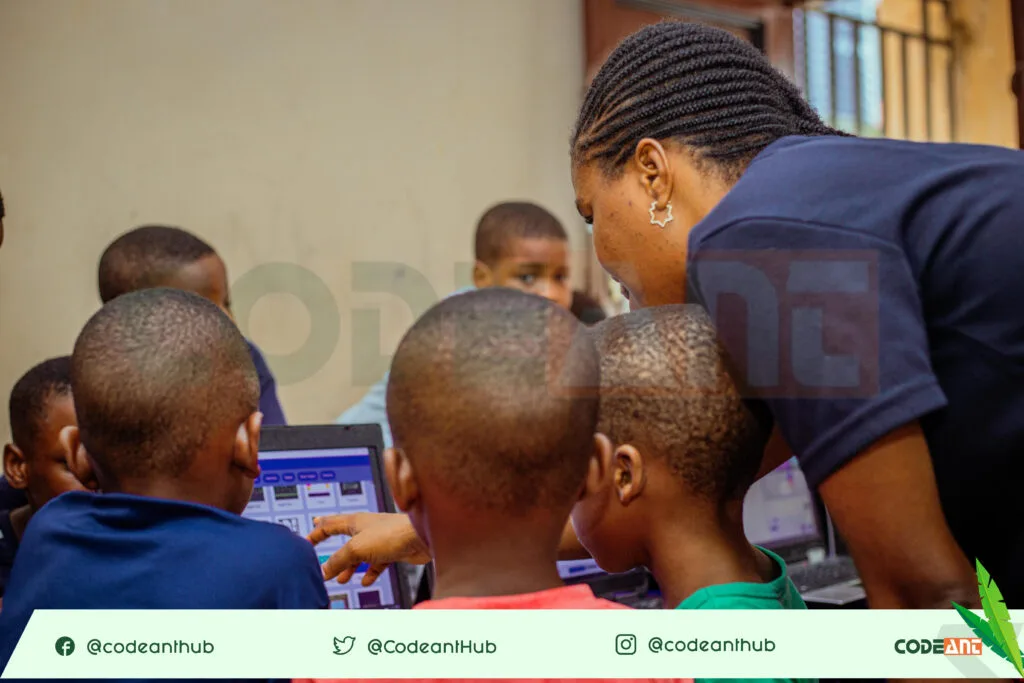 Our Instructor teaching the kids coding